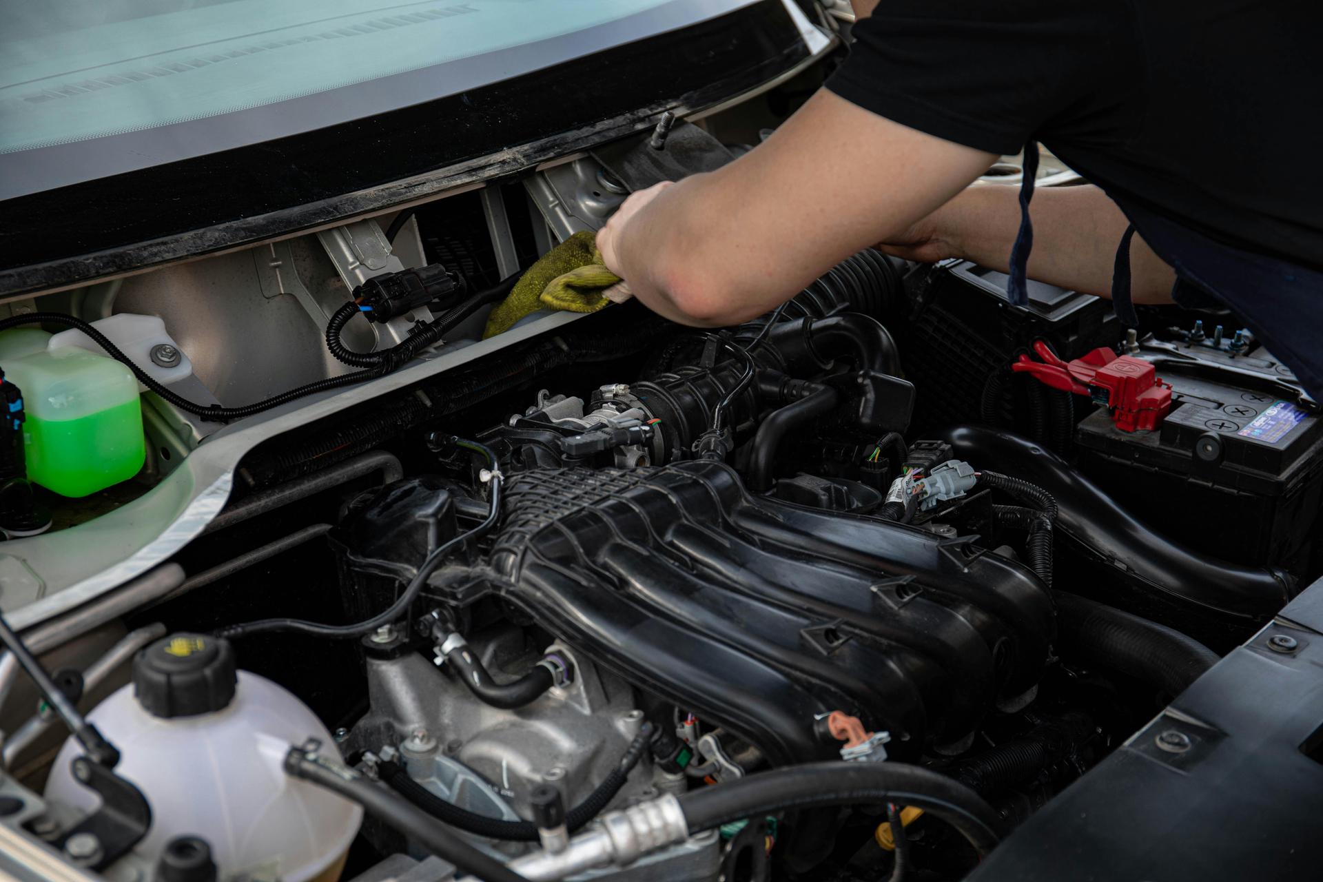 Mechanic conducts a service on a vehicle in Shurlock Row garage