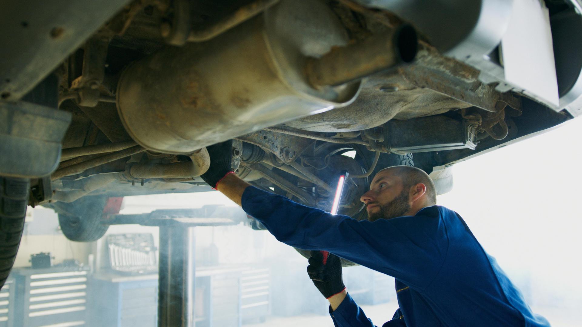 Technician inspects the DPF filter of a diesel vehicle at Shurlock Row garage