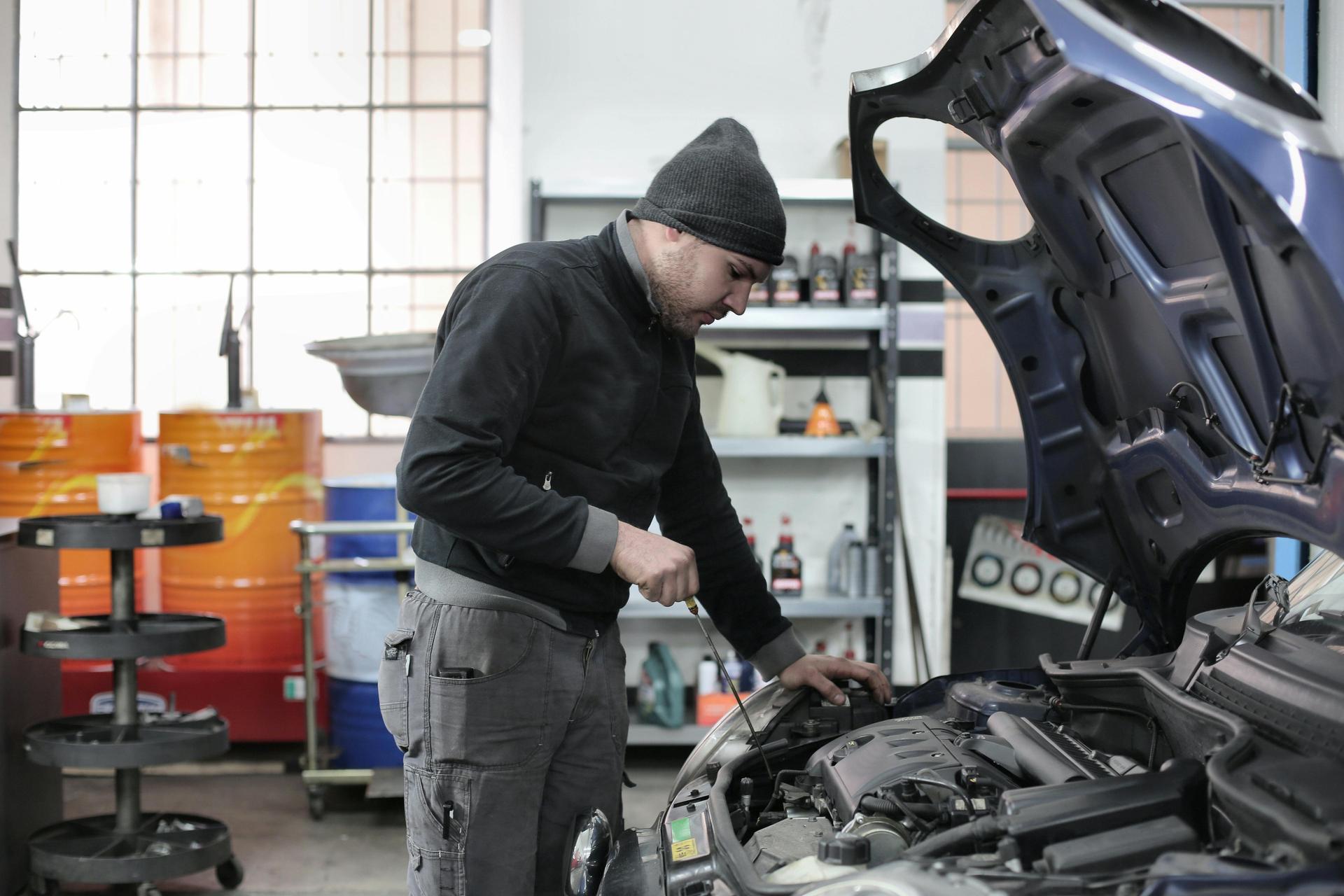 Technician at Shurlock Row conducts a seasonal check, looking beneath the car's bonnet