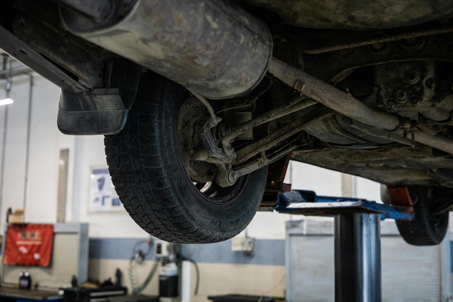 Underside of a vehicle's wheel, undergoing wheel alignment at Shurlock Row Garage